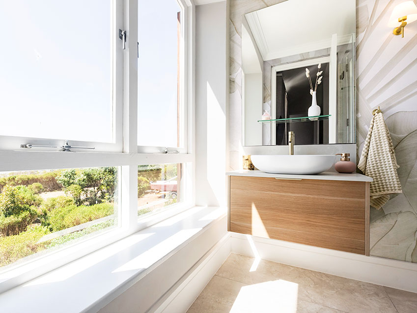 Benguela Cove Manor Guest Bathroom Three - Floating vanity, basin and mirror next to picture window